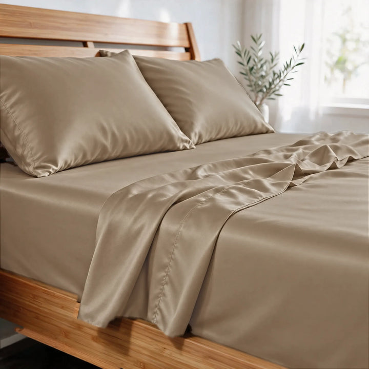 Taupe bamboo viscose sateen pillowcases close-up in morning light, showing the soft sheen