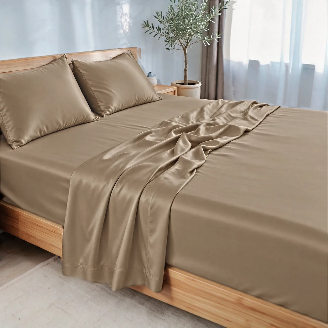 Taupe bamboo viscose sateen sheet set, three-quarter view with the flat sheet pulled back over the fitted sheet