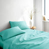 tiffany blue bamboo bed sheets with sateen weave from the Signature Collection, three-quarter angle showing natural folds and soft lighting from nearby window