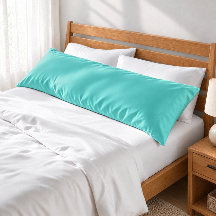 Tiffany Blue bamboo viscose sateen body pillowcase along the headboard of a made bed, three-quarter view from the foot of the bed