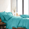modern bedroom with tiffany blue bamboo sateen sheet set on king bed, featuring matching pillowcases and duvet, styled with natural light and minimal decor