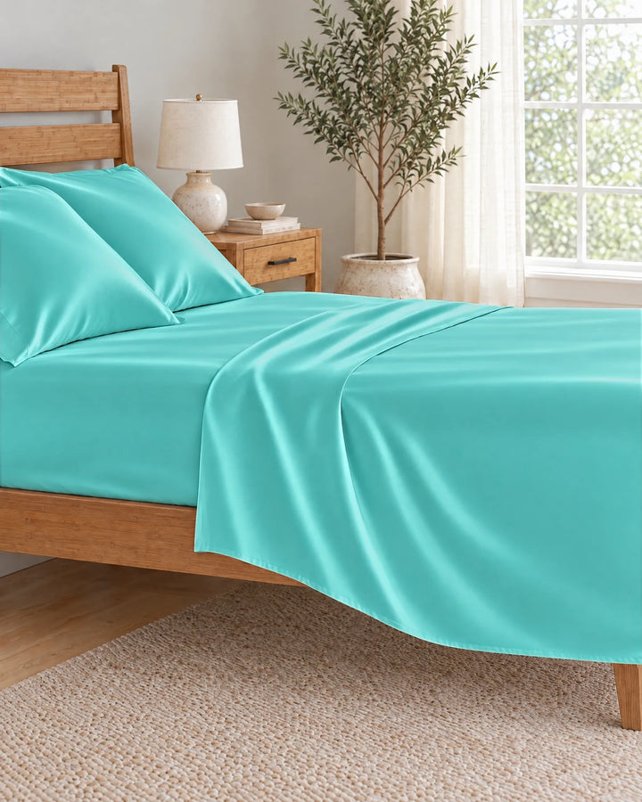 Tiffany Blue bamboo viscose flat sheet pulled back in a soft morning drape over the mattress