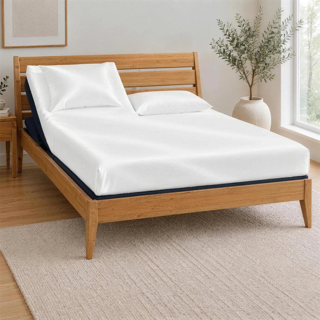 White bamboo viscose Top Split King fitted sheet on one king mattress, split at the head only, on the BT3000 Split Top King adjustable base inside a Greenington Sienna bamboo frame, left head section raised