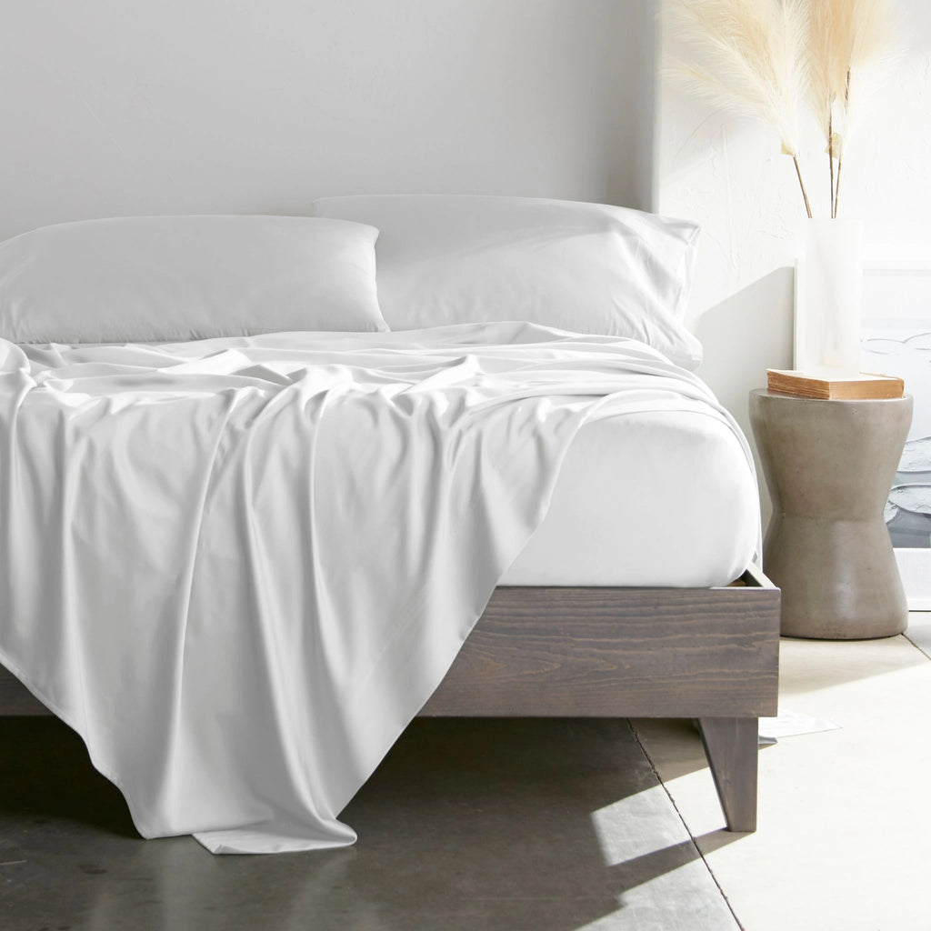 white bamboo bed sheets with sateen weave from the Signature Collection, shown from the foot of the bed with a draped flat sheet and matching pillowcases