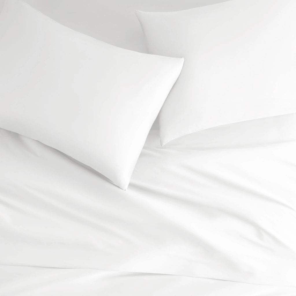 white bamboo bed sheets with sateen weave from the Signature Collection, overhead view highlighting smooth texture and matching pillowcases