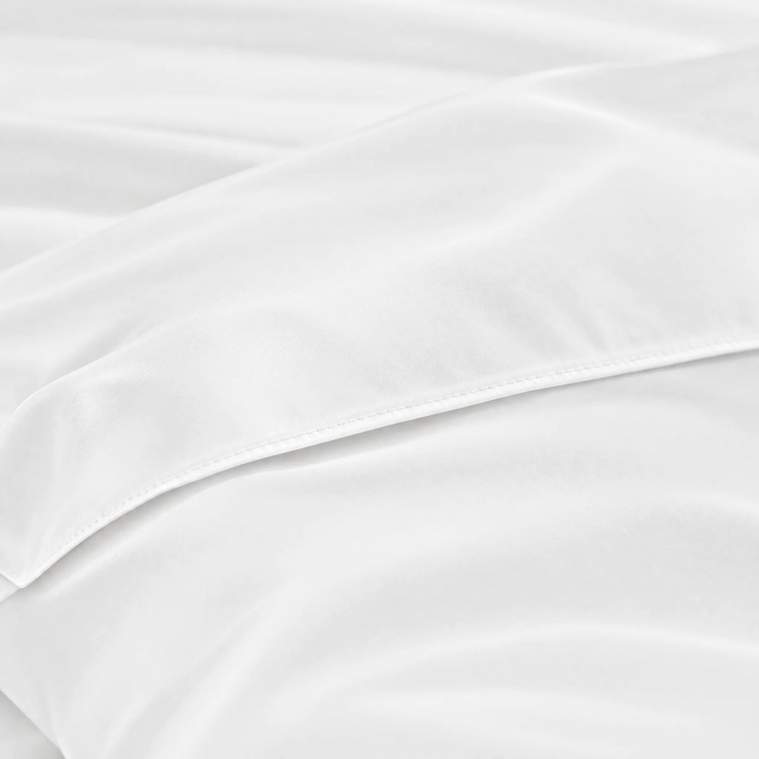 White bamboo viscose sateen body pillowcase macro close-up of silky sateen folds and stitched envelope closure