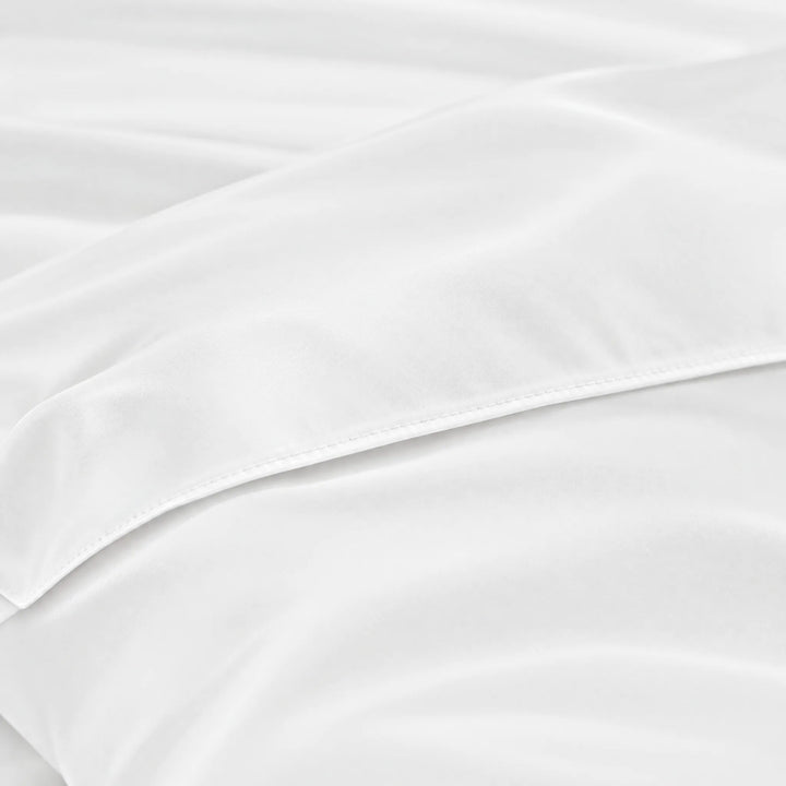 White bamboo viscose sateen body pillowcase macro close-up of silky sateen folds and stitched envelope closure