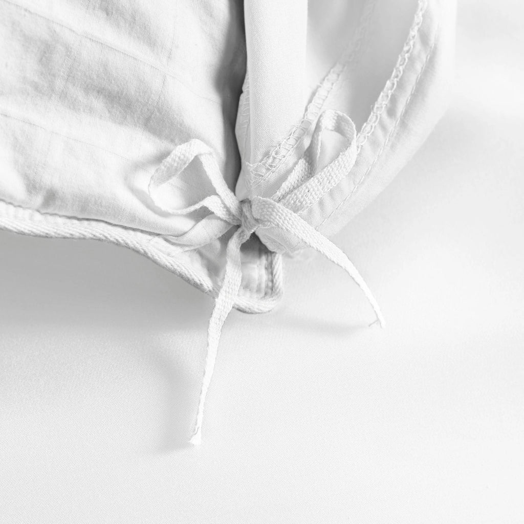 white bamboo duvet cover from the Signature Collection, close-up of internal corner tie securing white insert with smooth sateen fabric