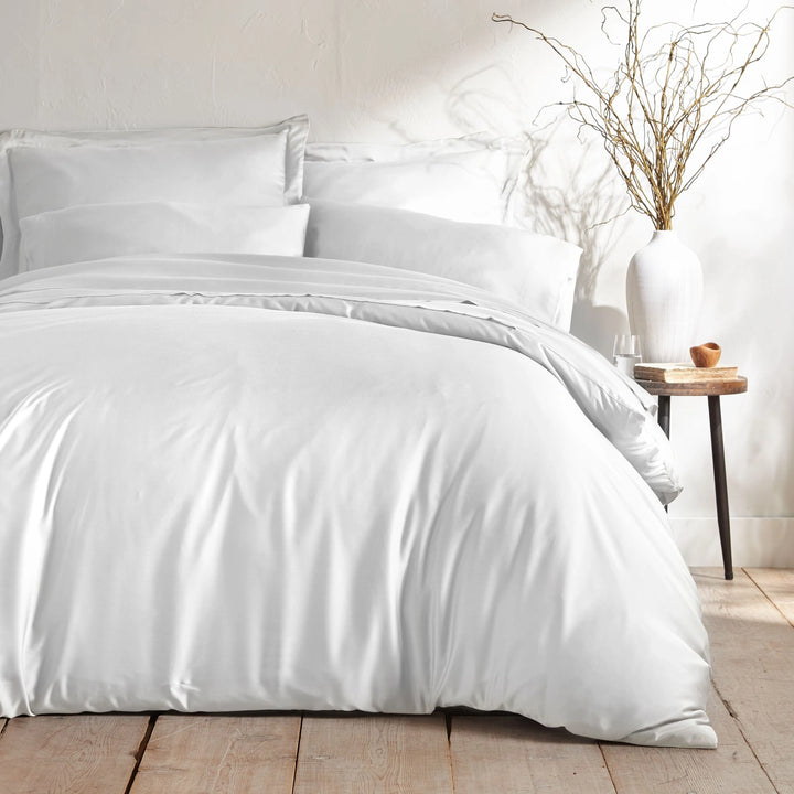 white bamboo bed sheets with sateen weave from the Signature Collection, shown foot view with matching pillowcases and a modern nightstand