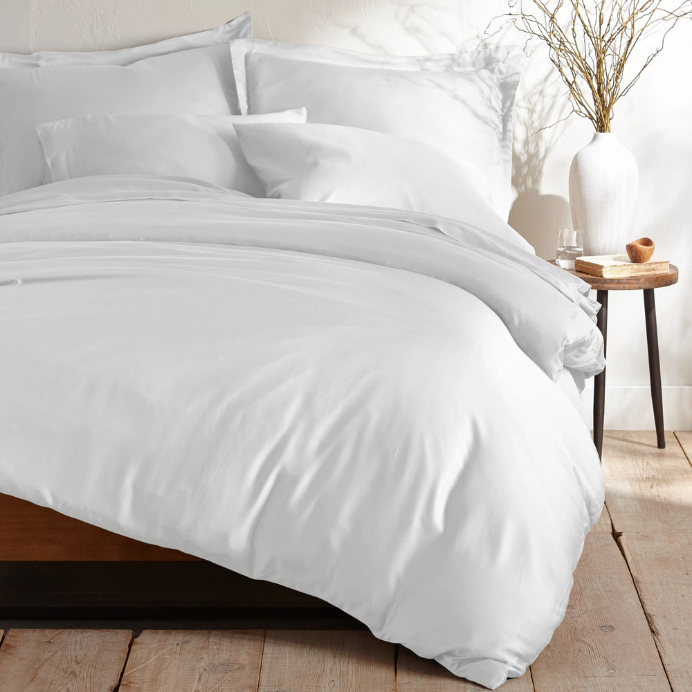 white bamboo sateen bedding set with pillowcases and duvet on king bed, styled in minimal bedroom with rustic wood floors and ceramic vase decor