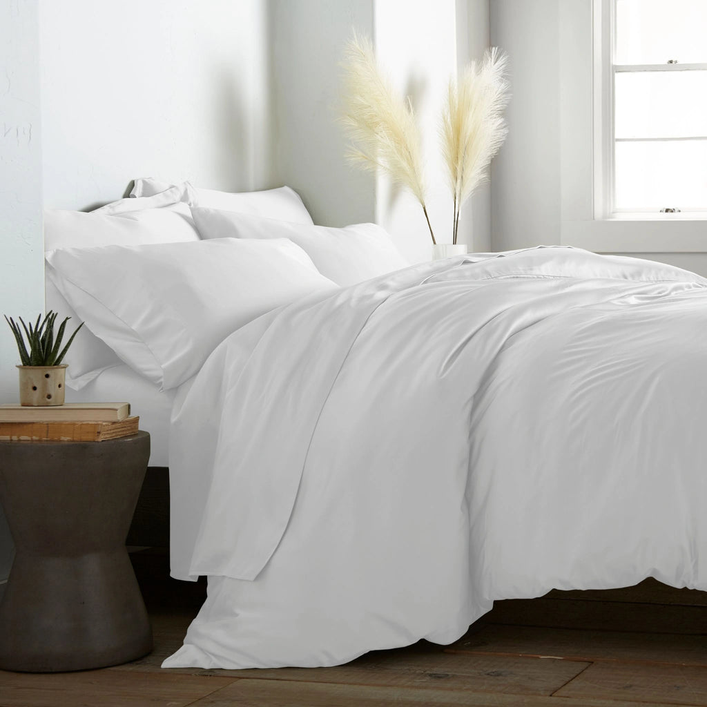 modern bedroom with white bamboo sateen sheet set on king bed, featuring matching pillowcases and duvet, styled with natural light and minimal decor