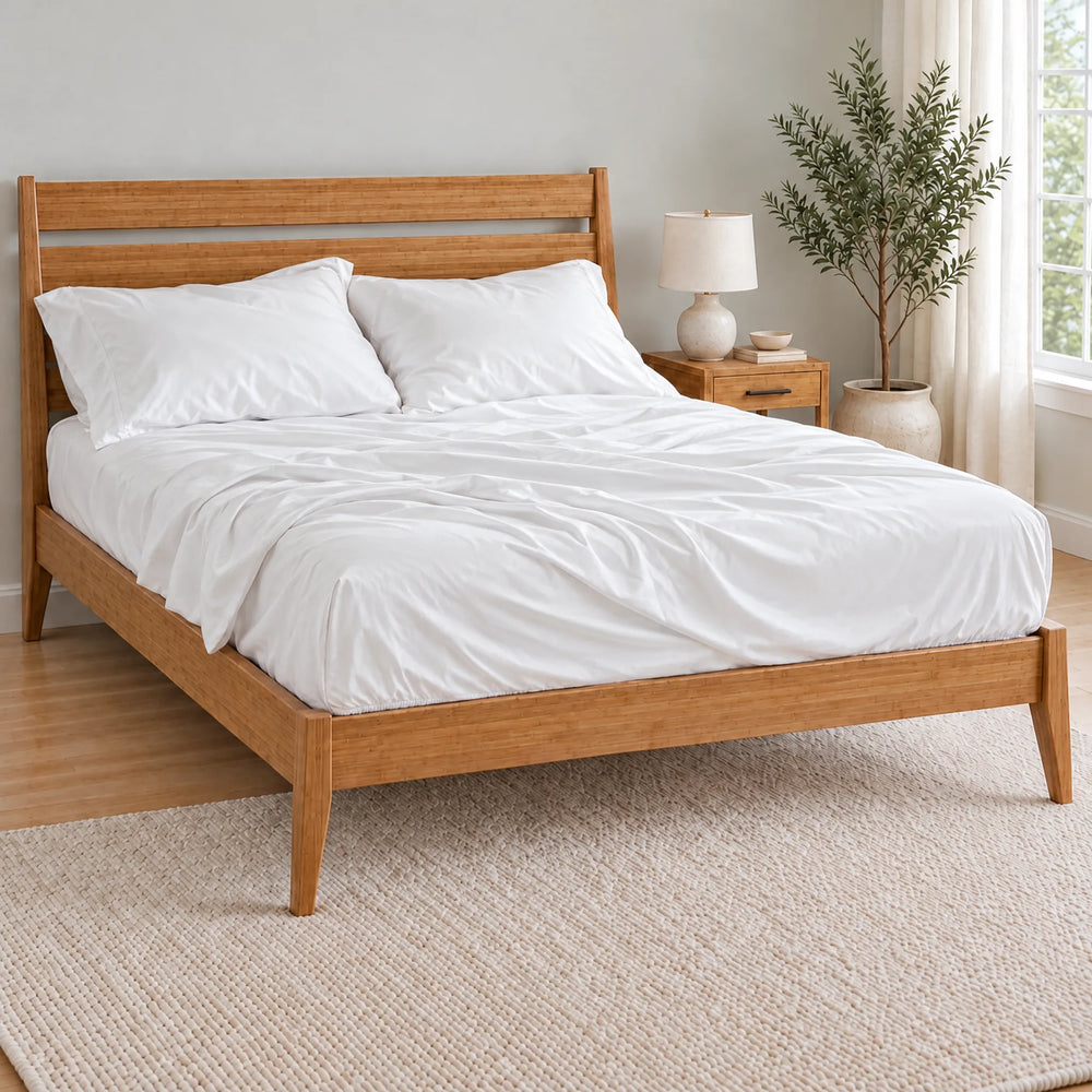 White bamboo viscose pillowcases on a relaxed, softly rumpled bed in a bright bamboo bedroom