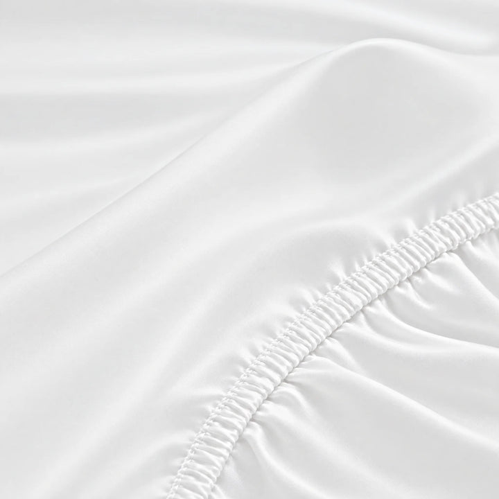White bamboo viscose fitted sheet stitched elastic hem macro close-up of smooth silky sateen, from the sheet set
