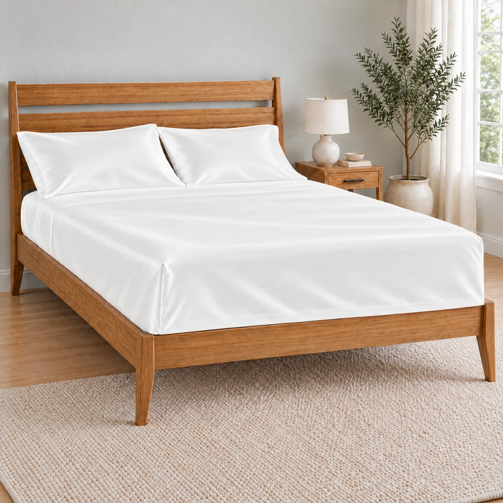 White bamboo viscose flat sheet with a tucked hospital corner on a made bed, from the sheet set