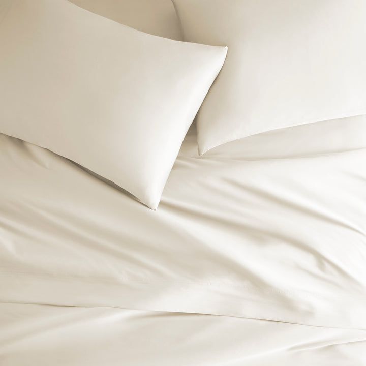 ivory bamboo bed sheets with sateen weave from the Signature Collection, overhead view highlighting smooth texture and matching pillowcases