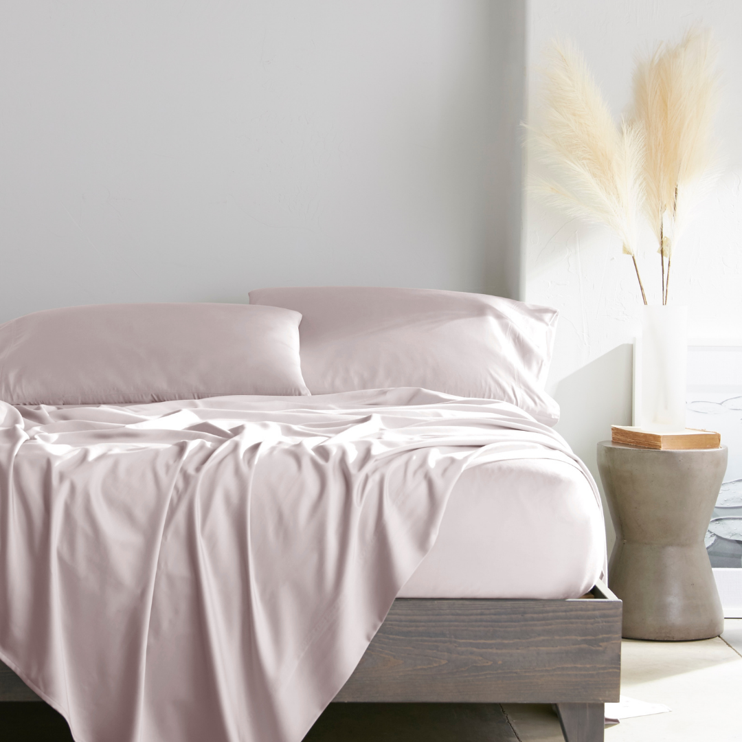 mauve bamboo bed sheets with sateen weave from the Premium Collection, shown from the foot of the bed with a draped flat sheet and matching pillowcases