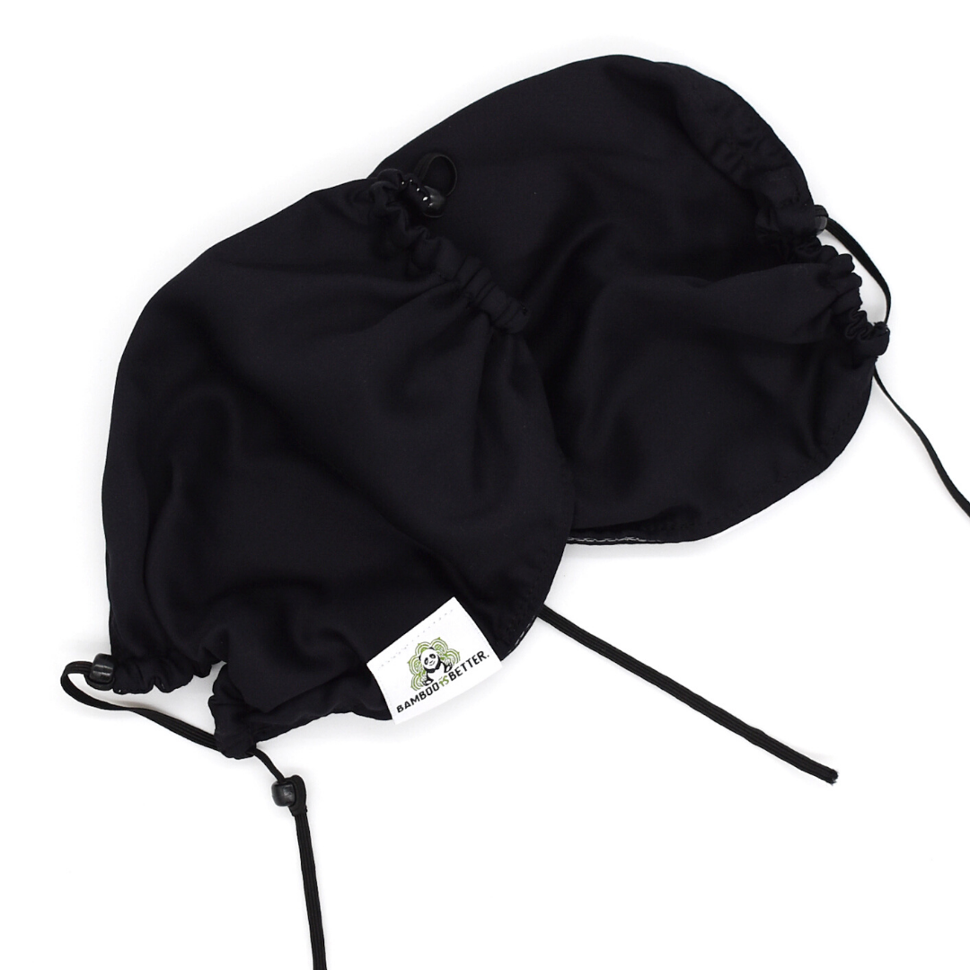 Reversible fabric face mask in black, with adjustable ear loops and a brand label for a comfortable and secure fit.