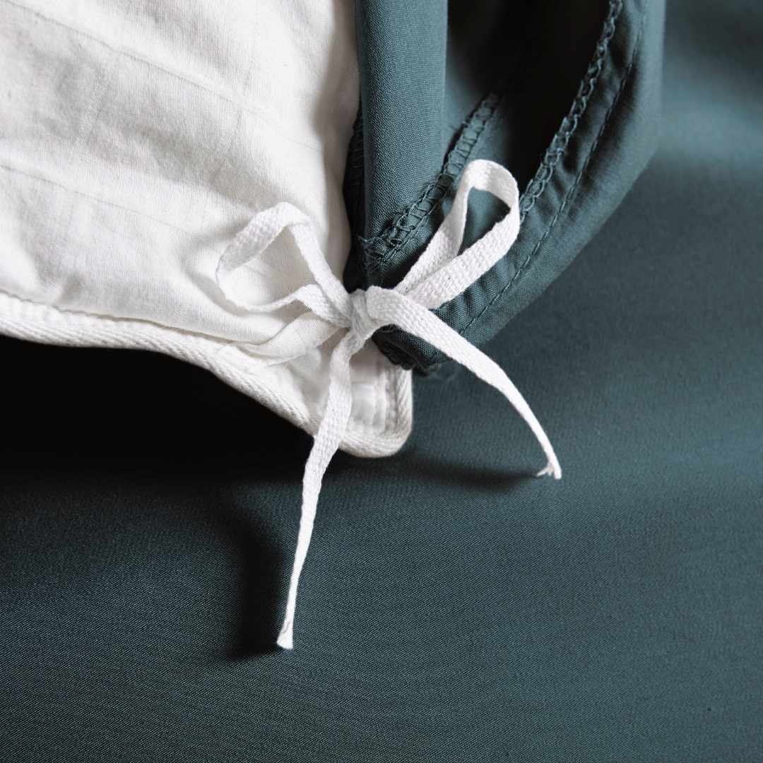 slate bamboo duvet cover from the Signature Collection, close-up of internal corner tie securing white insert with smooth sateen fabric