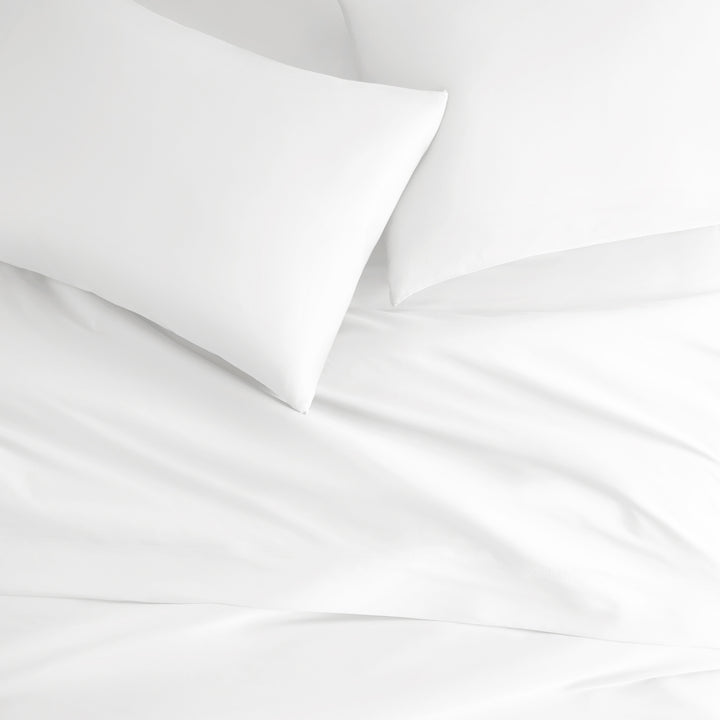 white bamboo bed sheets with sateen weave from the Signature Collection, overhead view highlighting smooth texture and matching pillowcases