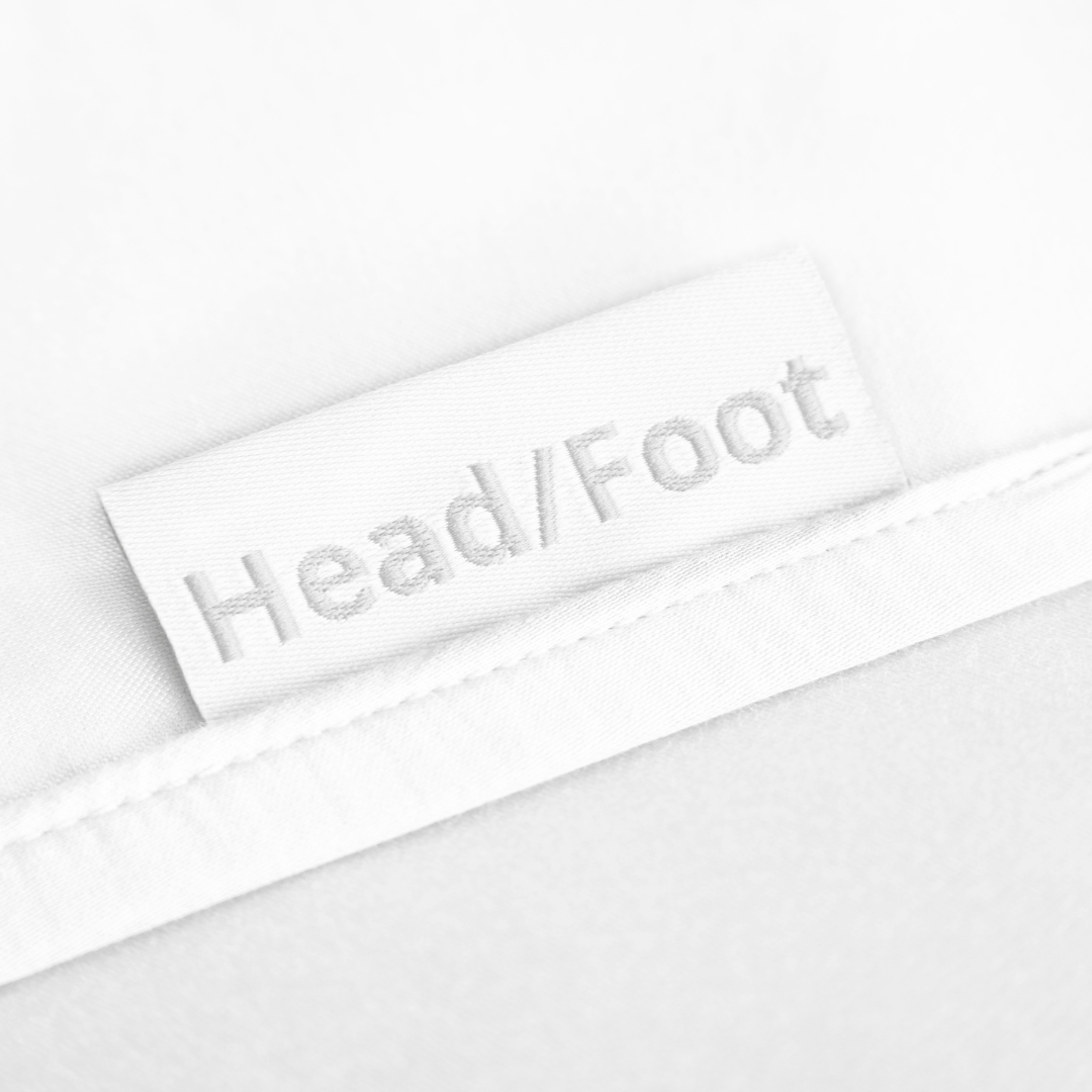 white bamboo bed sheets with clearly labeled 'head' and 'foot' tags for easy bed-making